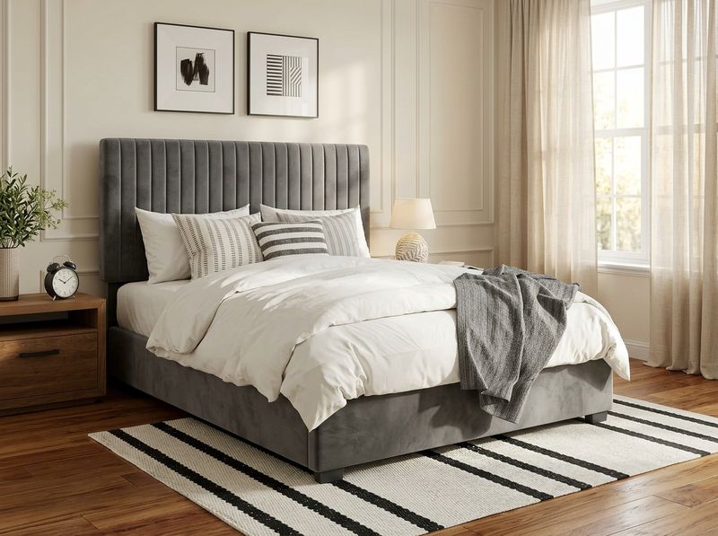 Side profile of velvet vertical channel tufted headboard at full extension above mattress and topper stack