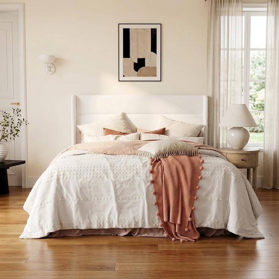 White Full velvet wingback with horizontal channel tufted headboard in guest room