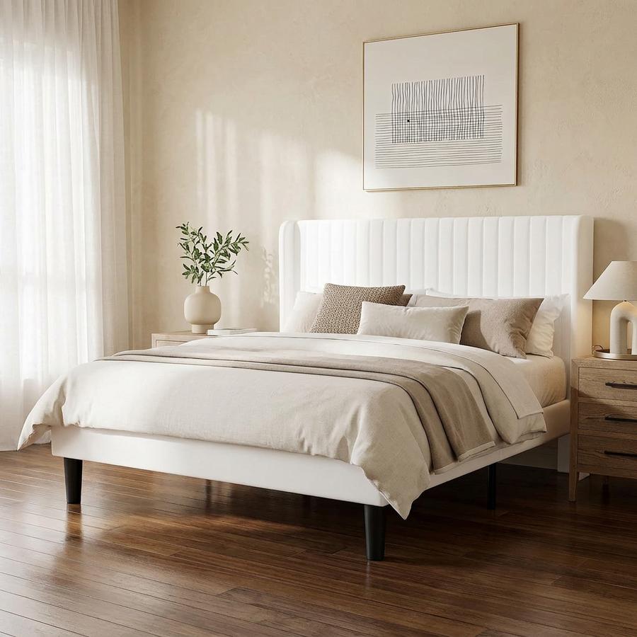 White velvet wingback Queen bed in a teen bedroom against a cream wall
