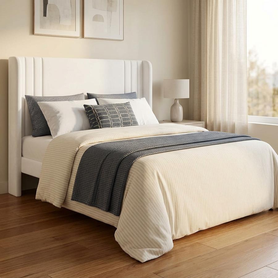 White velvet wingback Full bed frame on hardwood floor with linen curtains